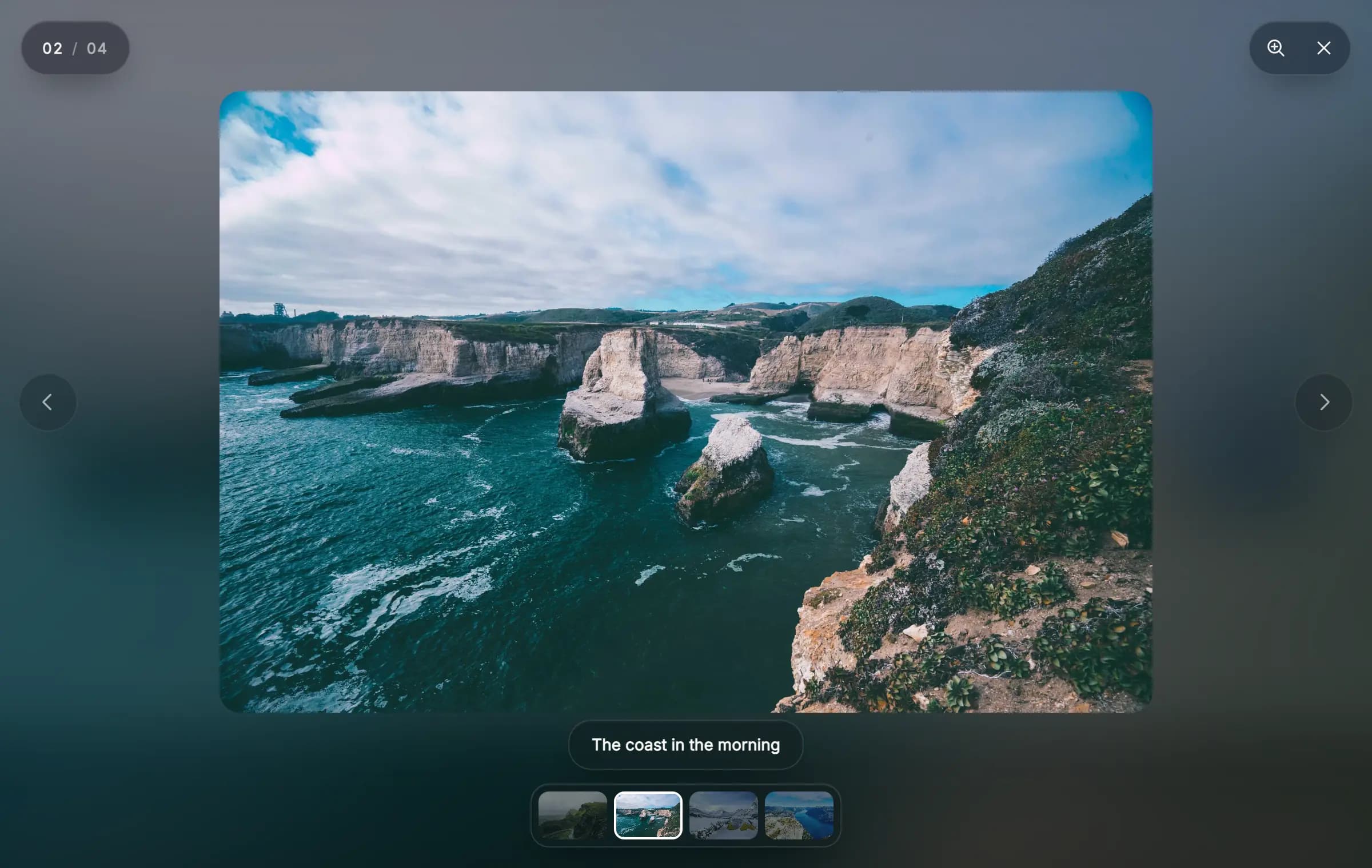 The lightbox open on the second of four photos, with a counter, zoom and close buttons, side arrows, a caption and a row of thumbnails